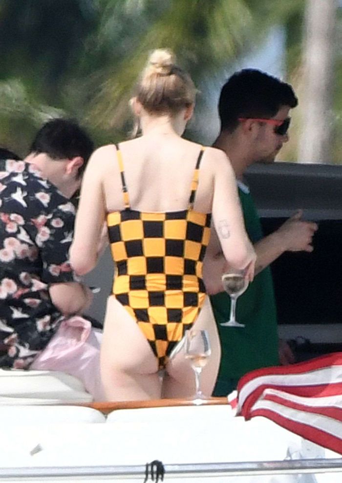 Sophie Turner In A Checkered Swimsuit On A Boat