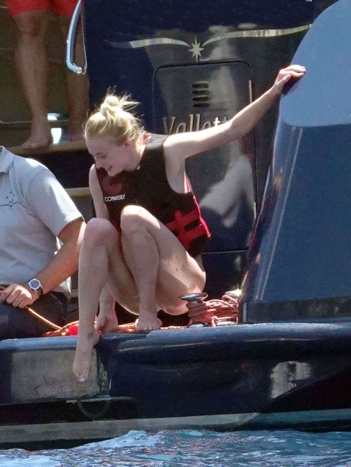 Sophie Turner In A White Swimsuit On A Yacht In Italy